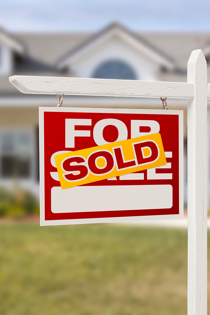 Red Sold For Sale Real Estate Sign in Front of House.